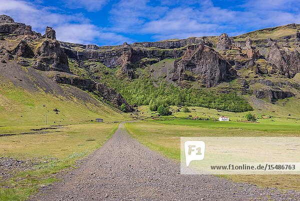 Farm among rocky hills in south part of Iceland.