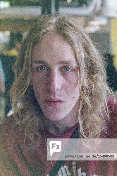 Berlin Germany. Portrait of a young adult blonde male with long hairdue.