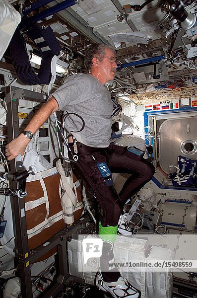 Astronaut John L. Phillips Expedition 11 NASA Space Station science officer and flight engineer uses the Cycle Ergometer with Vibration Isolation System (CEVIS) while participating in the FootGround Reaction Forces During Spaceflight (FOOT) experiment in the Destiny laboratory of the International Space Station. Phillips wore the specially instrumented Lower Extremity Monitoring Suit (LEMS) cycling tights outfitted with sensors during the experiment.