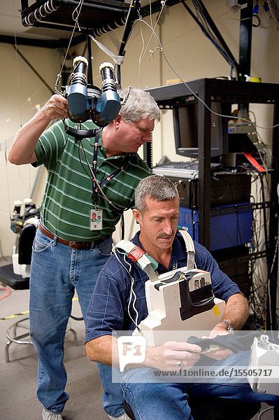 NASA astronaut Dan Burbank Expedition 29 flight engineer and Expedition 30 commander uses virtual reality hardware in the Space Vehicle Mock-up Facility at NASA's Johnson Space Center to rehearse some of his duties on the upcoming mission to the International Space Station. This type of virtual reality training allows the astronauts to wear a helmet and special gloves while looking at computer displays simulating actual movements around the various locations on the station hardware with which they will be working. Crew instructor Jeff Hoblit assisted Burbank.