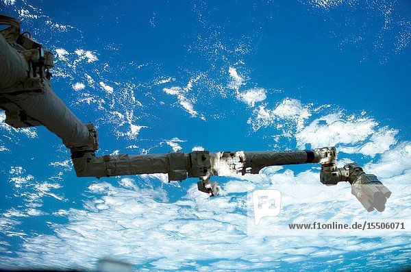 Backdropped against a blue and white Earth the Space Station Remote Manipulator System (SSRMS) or Canadarm2 is pictured in this digital still camera's view taken from the International Space Station (ISS).