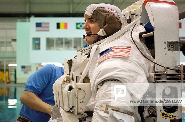 Astronaut Rex J. Walheim STS-122 mission specialist dons a training version of the Extravehicular Mobility Unit (EMU) spacesuit in preparation for a training session in the waters of the Neutral Buoyancy Laboratory (NBL) near Johnson Space Center.