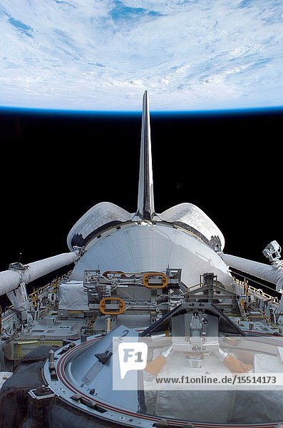 Discovery's cargo bay over Earth's horizon was photographed by one of the seven STS-114 crew members as the astronauts move within 24 hours of docking with the International Space Station (ISS).