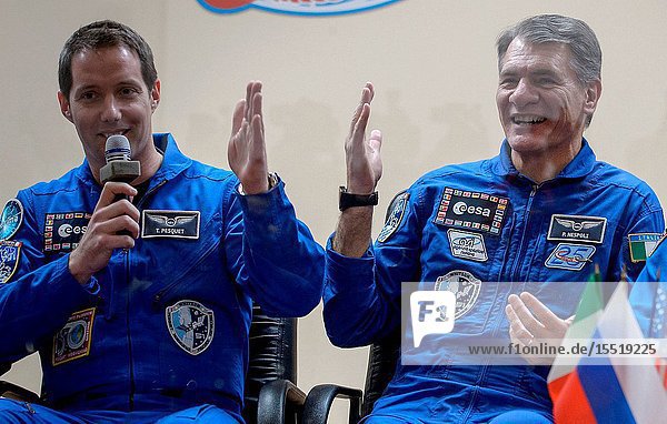 Expedition 50 ESA astronaut Thomas Pesquet  left  and backup crew member ESA astronaut Paolo Nespoli are seen in quarantine behind glass during a crew press conference  Wednesday  Nov. 16  2016 at the Cosmonaut Hotel in Baikonur  Kazakhstan. Pesquet  NASA astronaut Peggy Whitson  and Russian cosmonaut Oleg Novitskiy of Roscosmos will launch from the Baikonur Cosmodrome in Kazakhstan the morning of November 18 (Kazakh time.) All three will spend approximately six months on the orbital complex. Photo Credit: (NASABill Ingalls)