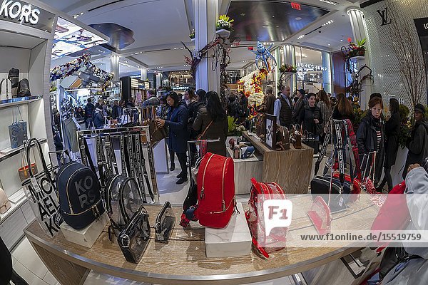 Michael Kors brand handbags in Macy's flagship department store in Herald Square in New York during the 45th annual Macy's Flower Show on opening day Sunday March 24 2019. Visitors flock to this year's show given an extraterrestrial title and theme 'Journey To Paradisios' to enjoy over 5000 flowers in horticultural displays evoking a sci-fi trip into outer space. The show runs until April 7. (© Richard B. Levine).