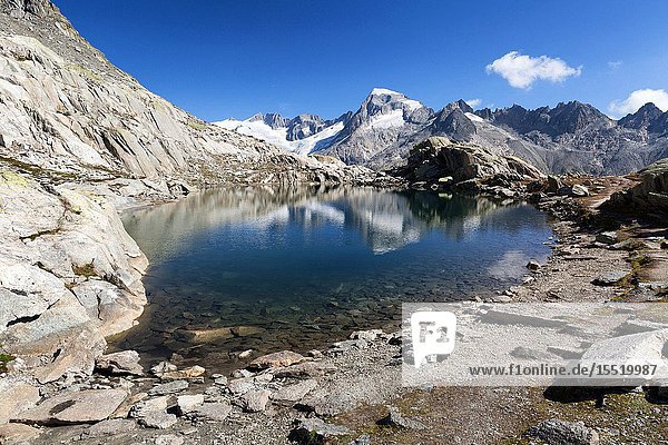 Galenstock and Rhone Glacier reflecting into Grätlisee near Grimselpass Goms Canton Valais Switzerland Europe.