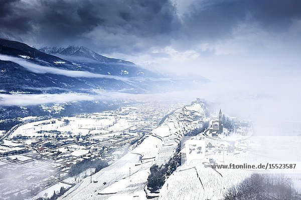 Aerial view of Castel Grumello and vineyards with snow. Montagna in Valtellina Valtellina Sondrio province Italy Europe.