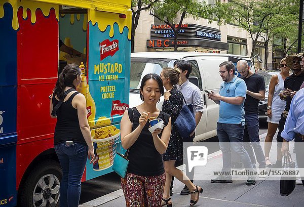 Ice cream lovers and mustard lovers flock to Midtown Manhattan for scoops of French's Mustard Ice Cream on Thursday August 1 2019. A collaboration with the trendy Coolhaus brand of ice cream the Mustard Ice Cream uses French's mustard to create its alarmingly bright yellow color. French's is a brand of McCormick. (© Richard B. Levine).