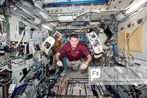 NASA astronaut Shane Kimbrough is seen executing the SPHERES-Halo experiment aboard the International Space Station. The investigation uses two small self-contained satellites (SPHERES) fitted with donut like rings to test wireless power transfer and formation flight using electromagnetic fields.