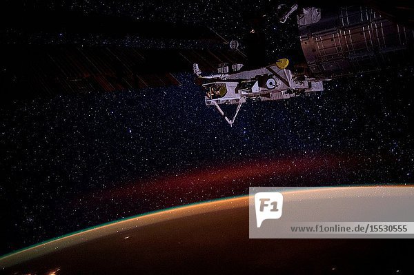 Earth's atmospheric glow the stars of the Milky Way and an experiment facility at the tip of Japan's Kibo lab module are seen in this night time photograph taken during Expedition 49.