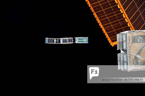 Three CubeSats are ejected from the NanoRacks CubeSat Deployer attached to the outside of the Japanese Kibo laboratory module. The trio are part of a subset CubeSats released during the week to monitor different gaseous molecules and electrical properties of the Earth's thermosphere to better understand space weather and its long term trends.