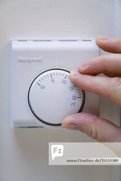 Thermostat on the wall being turned down