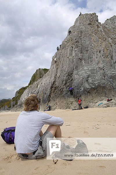 Man watching group of rock climbers