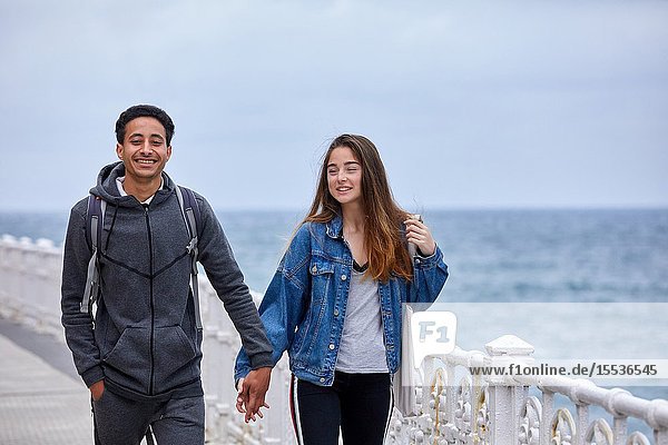 Couple of tourists visiting the city Multiracial young couple Donostia San Sebastian Gipuzkoa Basque Country Spain