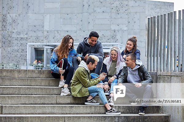 Young people sitting on stairs Zuloaga Square Donostia San Sebastian Gipuzkoa Basque Country Spain