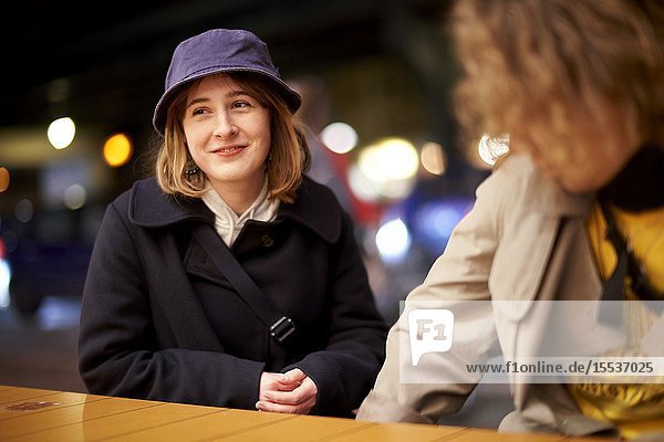 Pleased woman at night in city Berlin Germany.