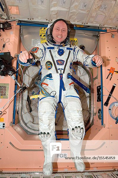 NASA astronaut Michael Fincke Expedition 18 commander attired in his Russian Sokol flight suit poses for a photo in the Unity node of the International Space Station.