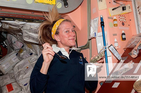 NASA astronaut Karen Nyberg Expedition 37 flight engineer prepares to eat a snack in the Unity node of the International Space Station.