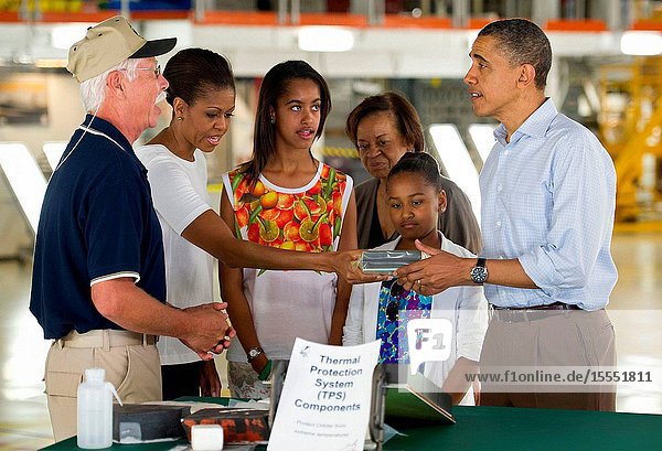Terry White United Space Alliance project lead for thermal protection systems left shows President Barack Obama and his family from left First Lady Michelle Obama Malia Marian Robinson and Sasha how tiles work on the space shuttle during their visit to the Orbital Processing Facility at the NASA Kennedy Space Center in Cape Canaveral Fla. Friday April 29 2011. Photo Credit: (NASABill Ingalls)