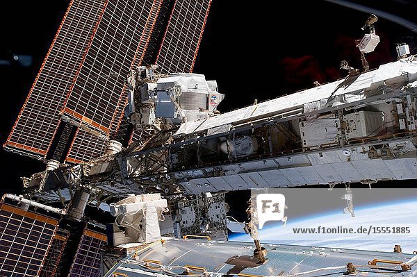 The starboard truss of the International Space Station is featured in this image photographed by an STS-134 crew member while space shuttle Endeavour remains docked with the station. The newly-installed Alpha Magnetic Spectrometer-2 (AMS) is visible at center left. The blackness of space and Earth's horizon provide the backdrop for the scene.