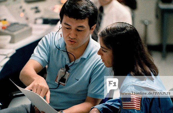 Barbara R. Morgan the Teacher-in-Space payload specialist backup trains for the STS-51L mission in the shuttle mission simulator (SMS). She is being briefed about the consoles and controls that operate the SMS in JSC's Mission Simulation and Training facility.
