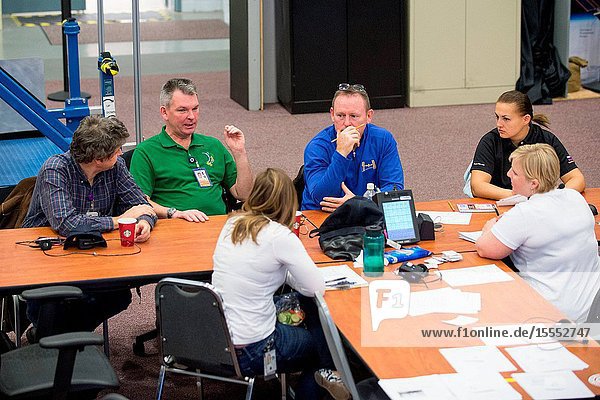 NASA astronaut Barry Wilmore (center) Expedition 41 flight engineer and Expedition 42 commander along with Russian cosmonauts Elena Serova (second right) and Alexander Samokutyaev both Expedition 4142 flight engineers are pictured during an emergency scenario training session in the Space Vehicle Mock-up Facility at NASA's Johnson Space Center. Interpreter Mark Pace (left) and training personnel assisted the crew members.