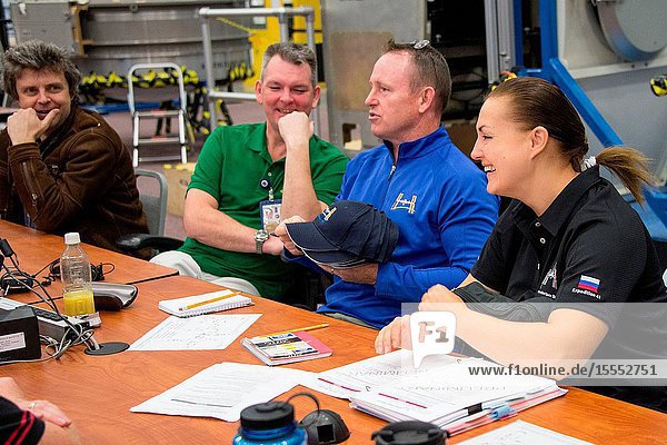NASA astronaut Barry Wilmore (second right) Expedition 41 flight engineer and Expedition 42 commander along with Russian cosmonauts Elena Serova and Alexander Samokutyaev both Expedition 4142 flight engineers are pictured during an emergency scenario training session in the Space Vehicle Mock-up Facility at NASA's Johnson Space Center. Interpreter Mark Pace (far left) assisted the crew members.