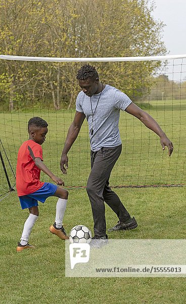 Young soccer player being coached on a football pitch. Hampshire England UK. April 2019.
