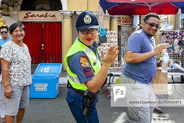 A Policewoman Dances In The Street With Festival Revellers During The Dinagyang Festival  Iloilo City  Panay Island  The Philippines.