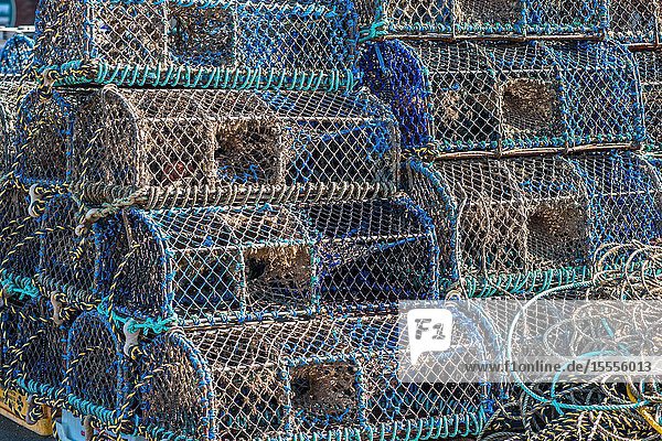 Crab and lobster pots or creels stacked on Wells-next-the-sea seafront. North Norfolk coast, East Anglia, England, UK.