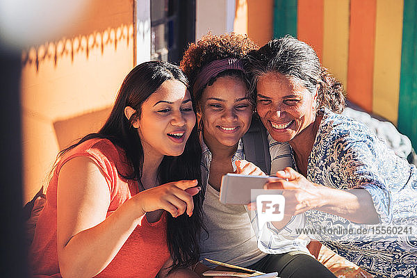 Glückliche Mutter und Töchter nehmen Selfie mit Smartphone