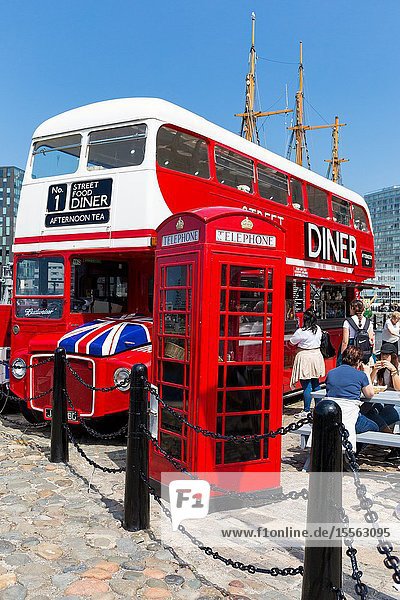 Routemaster bus converted into street cafe diner restaurant facility. Liverpool albert docks. Tourism in Merseyside England UK. Old fashioned Telephone box.