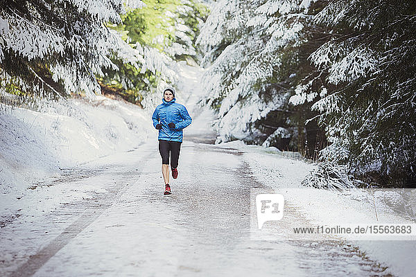 Man jogging in snowy woods