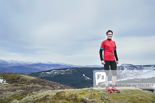Portrait man standing on mountaintop