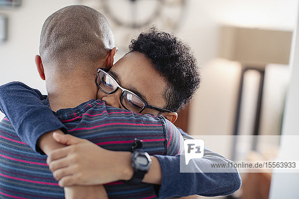 Affectionate son hugging father