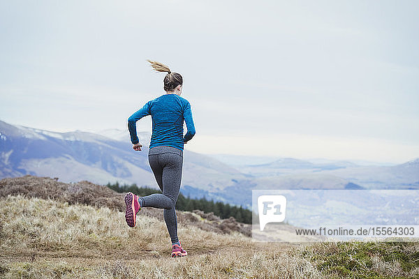 Woman jogging on mountain trail