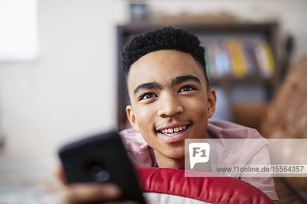 Smiling teenage boy with smart phone