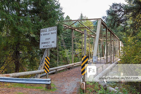A steel arch bridge no longer strong enough to support vehicles receives new life as a crossing for people and lighter machines.