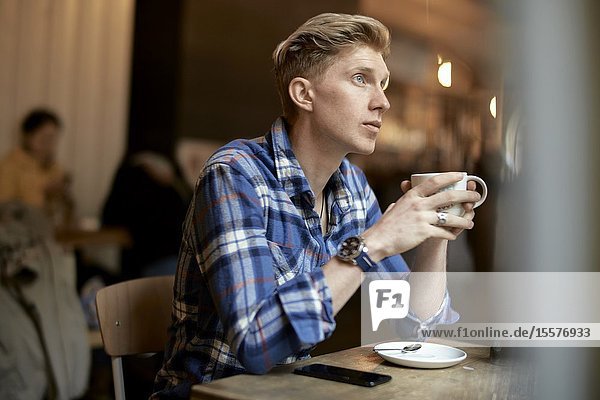 Young man in cafe Munich Germany.