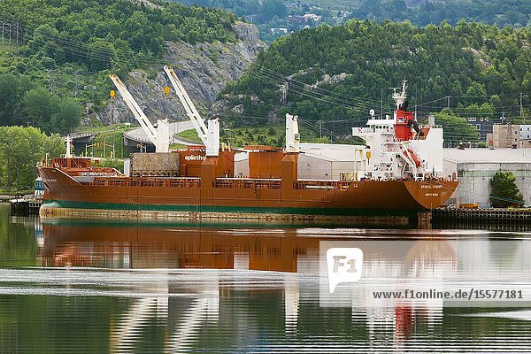 Cargo ship loading paper at paper mill at Corner Brook Newfoundland Canada.