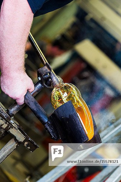 Glass worker spinning and shaping Molten glass Canada Halifax. Nova scotia. Harbour Waterfront.