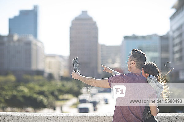 Junges Paar beim Fotografieren mit einem digitalen Tablett