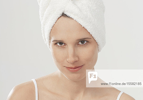 Young woman with towel wrapped around hair  portrait