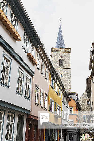 Low angle view of residential buildings and church against sky in Erfurt Germany