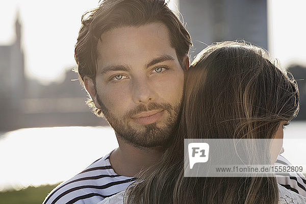 Germany  Cologne  Young couple hugging  smiling