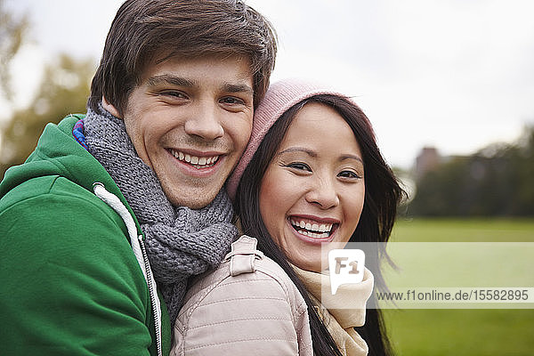 Germany  Cologne  Young couple in park  smiling  portrait