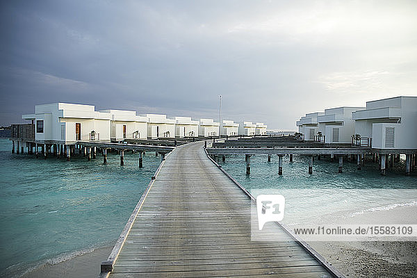 Abnehmende Perspektive des Piers  der zu den Villen über dem Meer auf den Malediven führt