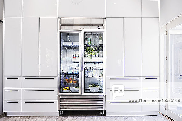 Glass refrigerator in modern kitchen