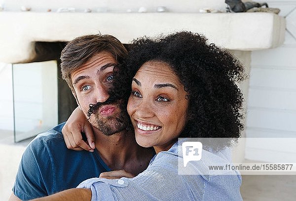 Couple taking selfie in beach house