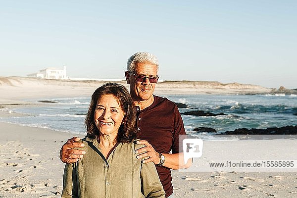 Senior couple enjoying sun on sandy beach